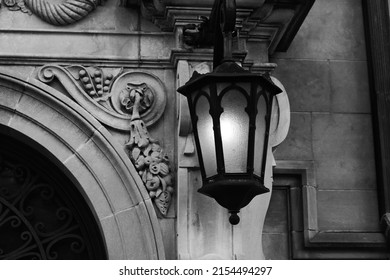 Beautiful Vintage Cast Iron Street Lamp Hanging On The Medieval Gothic Wall In Black And White.