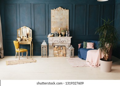 beautiful vintage colorful interior. classic room with wooden floor blue walls with moldings, dressing golden  table with mirror decorated with elements, yellow chair, fireplace, lanterns, pink sofa - Shutterstock ID 1319327609