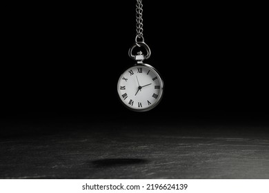 Beautiful Vintage Pocket Watch With Silver Chain On Black Background Above Dark Table. Hypnosis Session