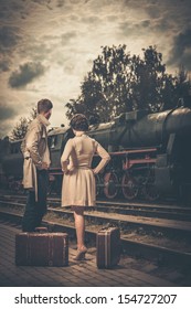 Beautiful Vintage Style Couple With Suitcases On  Train Station Platform