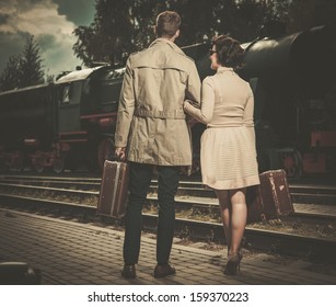 Beautiful Vintage Style Couple With Suitcases On  Train Station Platform