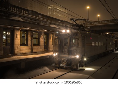 Beautiful Vintage Train Station With Train Arriving In The Snow On Overcast Night In Urban Chicago