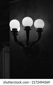 Beautiful Vintage Wall Sconce Glowing With A Bright Light In Black And White.