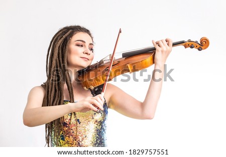 Beautiful violinist girl playing the violin