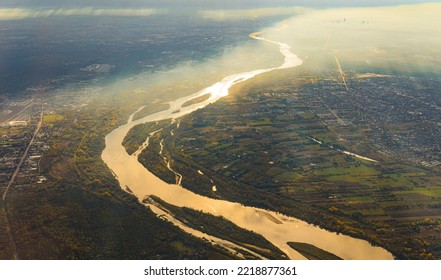 Beautiful Vistula River In Going Dividing Warsaw In Two City Parts. Aerial Perspective From Plane. Autumn Morning With Soft Sunshine And Fog Over The City. High Quality Photo