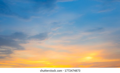 Beautiful Vivid sky painted by the sun leaving bright golden shades.Dense clouds in twilight sky in winter evening.Image of cloud sky on evening time.Evening Vivid  sky with clouds. 