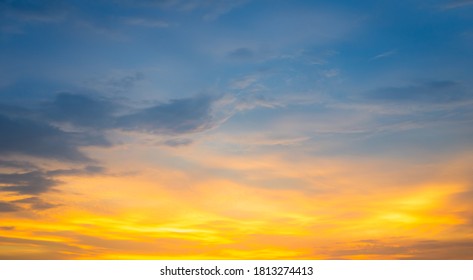 Beautiful Vivid Sky Painted By The Sun Leaving Bright Golden Shades.Dense Clouds In Twilight Sky In Winter Evening.Evening Vivid  Sky With Clouds. 