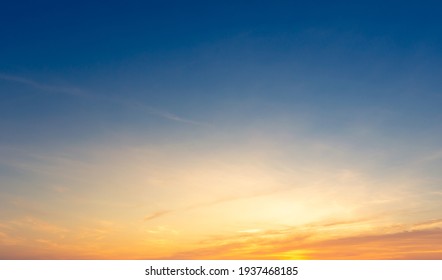 Beautiful Vivid sky painted by the sun leaving bright golden shades.Dense clouds in twilight sky in winter evening.Image of cloud sky on evening time.Evening Vivid sky with clouds. - Shutterstock ID 1937468185