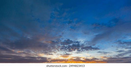 Beautiful Vivid sky painted by the sun leaving bright golden shades.Dense clouds in twilight sky in winter evening.Image of cloud sky on evening time.Evening Vivid sky with clouds - Powered by Shutterstock