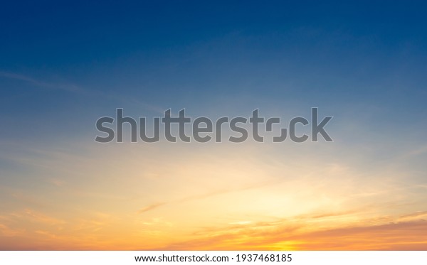 Beautiful\
Vivid sky painted by the sun leaving bright golden shades.Dense\
clouds in twilight sky in winter evening.Image of cloud sky on\
evening time.Evening Vivid sky with\
clouds.