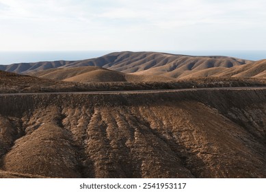 Beautiful volcanic landscape with empty road between the mountains from the viewpoint Mirador Astronomico de Sicasumbre around Pajara, Fuerteventura, Canary Islands, Spain - Powered by Shutterstock