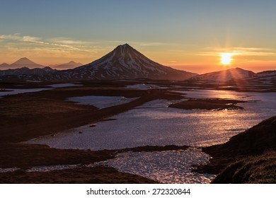 Beautiful volcano landscape of Kamchatka Peninsula: sunrise over Vilyuchinsky Volcano (Vilyuchik Volcano) - popular travel destinations for tourists and travelers visiting Kamchatka Region in Russia.