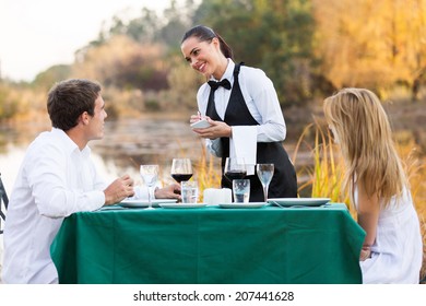 beautiful waitress taking order from customer outdoors
