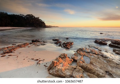 Beautiful warm golden sunlight streaming onto the beach in Jervis Bay Australia