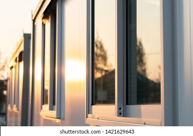 Beautiful Warm Sunrise Light Shining On House Glass Window With Town Nature Reflection In The Morning, Modern Home Exterior View