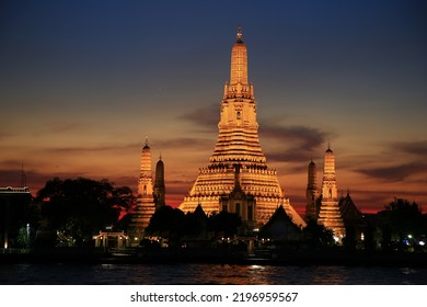 Beautiful Wat Arun On Sunset And Night Light Pagoda On Chao Phaya River, Bangkok, Thailand