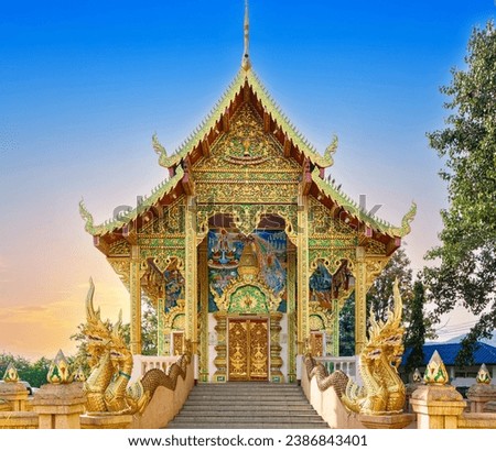 beautiful Wat Buddhist temples in Chiangmai Chiang mai Thailand. Decorated in beautiful ornate colours of red and Gold and Blue. Lovely sunset