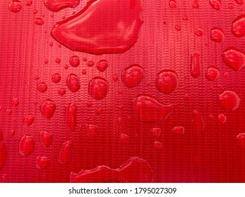 Beautiful Water Droplets On A Red Plastic Sheet.