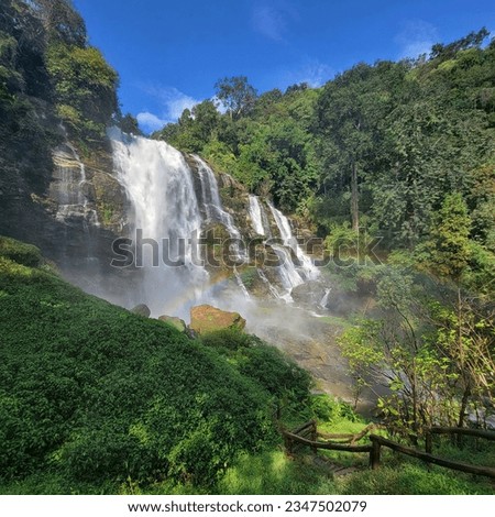 Beautiful water falls with a rainbow in Wachirathan Falls in Chiang Mai, Thailand 