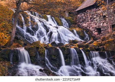 Beautiful Waterfall In Autumn Forest In Jonkoping, Sweden. Long Exposure. Selective Focus.