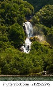 Beautiful Waterfall Between Green Trees On Nærøyfjord In Early Summer In Norway