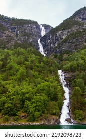 Beautiful Waterfall Between Green Trees On Nærøyfjord In Early Summer In Norway