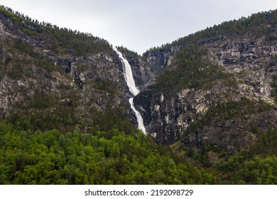 Beautiful Waterfall Between Green Trees On Nærøyfjord In Early Summer In Norway