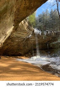 Beautiful Waterfall and Icicles on Winter Day in Ohio Park Recess Cave in Forest
