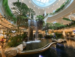 The Beautiful Waterfall In The Middle Of The Forest In The Mall Is Beautiful And Admirable.