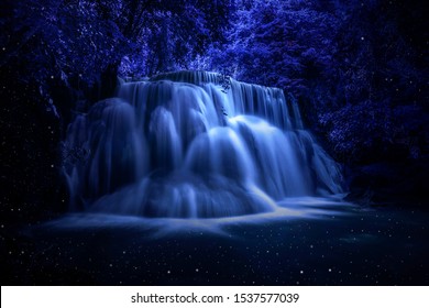 Beautiful waterfall nature scenery of colorful at a night deep tropical fantasy jungle