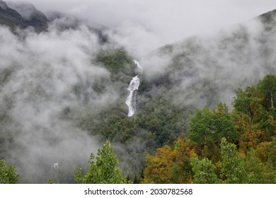 beautiful waterfall surrounded for clouds and forest - Powered by Shutterstock