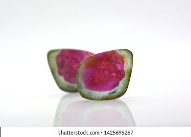 Beautiful watermelon tourmalines pink and green polished and shiny on white background