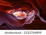 Beautiful waves carved into the sandstone rock through centuries of flash flooding in lower Antalope Canyon in Page, Arizona.