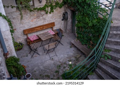 Beautiful Weathered Wooden Bank, Chairs And Table In Vintage Style, Calming And Relaxing Concept, Abandoned Place In Crowded City Centre, Slovakia, Europe