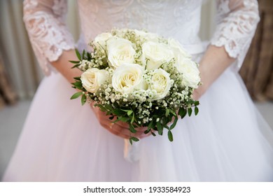 Beautiful Wedding Bouquet Of Flowers In The Hands Of The Bride