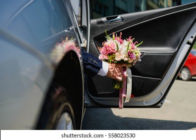 beautiful wedding bouquet with gentle flowers in hands of the groom