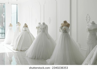 Beautiful wedding bridal dresses on mannequin in showroom in mall. - Powered by Shutterstock