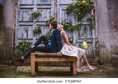 Beautiful Wedding Casual Couple In Love On The Decorated Wooden Wall Of Facrory