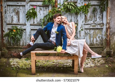 Beautiful Wedding Casual Couple In Lovelooking Forvard On The Decorated Wooden Wall Of Facrory