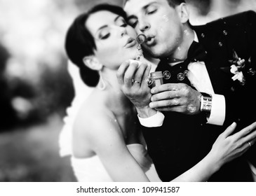 beautiful wedding couple blowing bubbles - Powered by Shutterstock