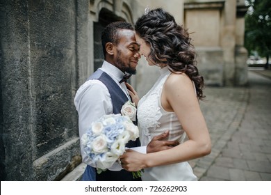 Beautiful wedding couple celebrating their wedding day ,happy african american groom and caucasian bride