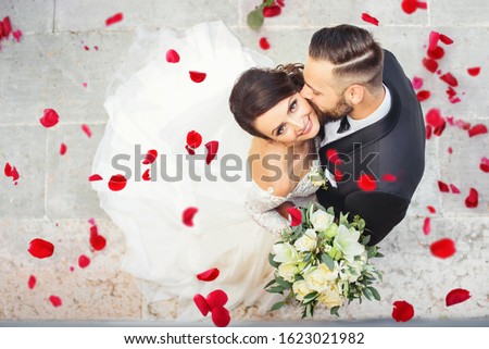 Beautiful wedding couple cuddling on their wedding day 