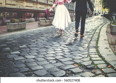 Beautiful Wedding Couple Is Leaving The Wedding Romantic. Walking Away 