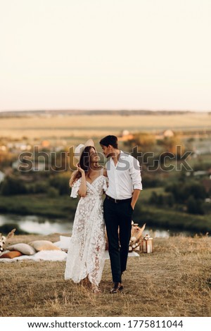 Beautiful wedding couple in nature in boho style. Wedding in the European style of fineart at sunset.