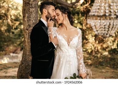 Beautiful wedding couple of newlyweds hugging on the background of the forest. - Powered by Shutterstock