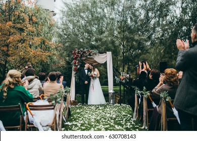 Beautiful Wedding Couple On The Wedding Autumn Ceremony 