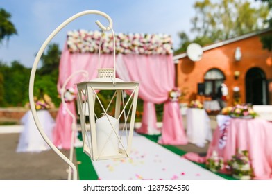 beautiful wedding decor. Wedding candle lantern on the background of the wedding arch