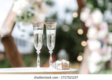 Beautiful wedding decor. Ceremony, floristry and decoration of halls, banquets, wedding arches, rings in a casket, invitation, bright flowers, details and elements of a wedding day.
