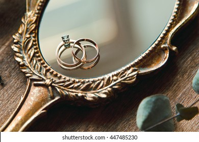 Beautiful wedding rings on a vintage mirror