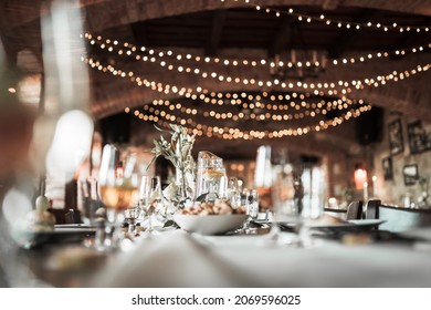 Beautiful wedding room with wedding table with food, flowers anddrinks, decorations,lights  - Shutterstock ID 2069596025